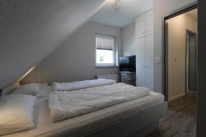 Ein Bett oder Betten in einem Zimmer der Unterkunft DHH Meisenweg 32