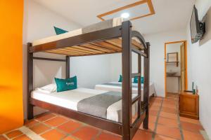 a bedroom with two bunk beds in a room at Ayenda Brisas del Caribe in Santa Marta