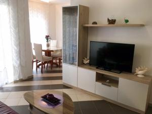 a living room with a flat screen tv in a cabinet at Apartment Mirella in Umag