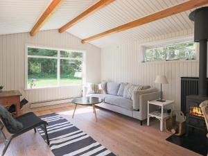 a living room with a couch and a table at 6 person holiday home in Gilleleje in Gilleleje