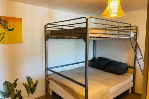 a bedroom with a bunk bed in a room at Charmante maison avec jacuzzi in Montazels