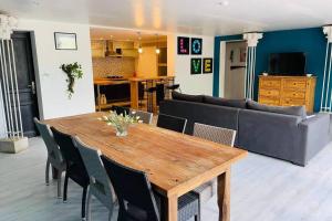 a living room with a wooden table and a couch at Charmante maison avec jacuzzi in Montazels