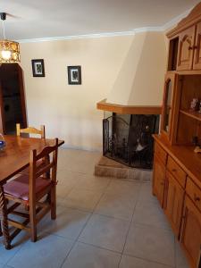 a dining room with a table and a fireplace at Enjoy Gredos in El Arenal +5 photos
