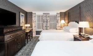 a hotel room with two beds and a flat screen tv at Historic Inns of Annapolis in Annapolis +116 photos