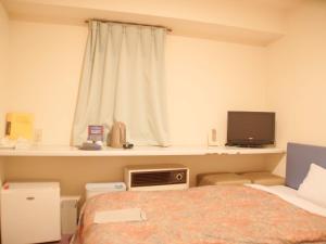 Postel nebo postele na pokoji v ubytování Business Hotel Chateau Est Takamatsu + 27 fotografií