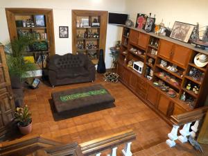 a living room with a chair and a couch and shelves at Hotel Boutique El Sueño del Coronel in Río Verde