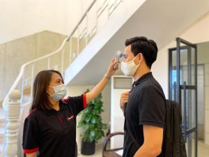 a man and a woman wearing face masks at Vienna Hotel in Ho Chi Minh City