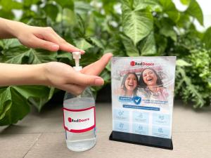 a person is holding a bottle of water next to a pamphlet at Vienna Hotel in Ho Chi Minh City