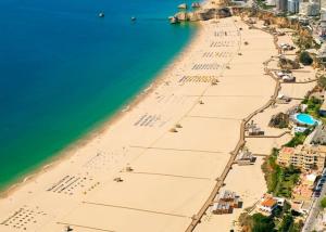 una vista aérea de una playa con agua y edificios en Clube Praia Mar by amcf, en Portimão