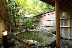 una pequeña piscina de agua en un jardín en Izumiya Zenbe, en Matsumoto