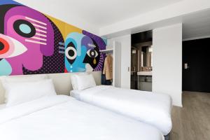 Postel nebo postele na pokoji v ubytování B&B HOTEL St Gallen