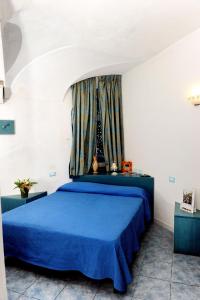 Postel nebo postele na pokoji v ubytování Hotel La Ninfea