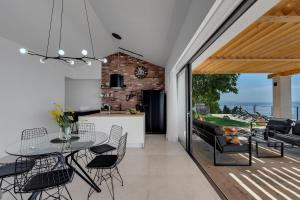 a dining room and kitchen with a table and chairs at Villa Kostela Makarska in Makarska