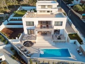 an aerial view of a house with a swimming pool at Villa Allure in Sutivan