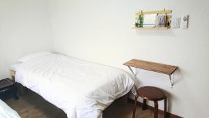 En eller flere senger på et rom på Kawayu Onsen Guesthouse NOMY