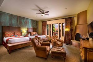 a bedroom with a bed and a couch and a chair at Gateway Canyons Resort, a Noble House Resort in Gateway