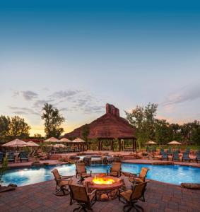 a pool with a fire pit and chairs and a resort at Gateway Canyons Resort, a Noble House Resort in Gateway