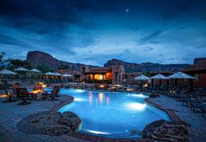 a pool at a resort with mountains in the background at Gateway Canyons Resort, a Noble House Resort in Gateway