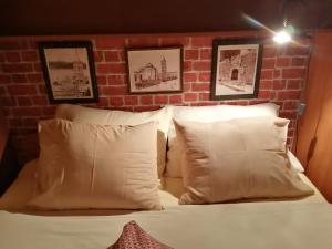 a bedroom with a brick wall and a bed with pillows at Apartments Tamara in Sukošan