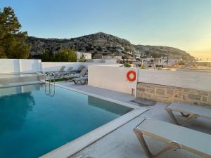 a swimming pool with chairs on the roof of a house at Antonios Hotel Apartments in Matala