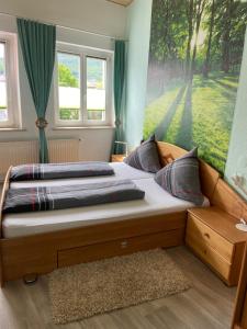 a bedroom with a large bed with a window at Apartments & Ferienhaus Senftner in Thale