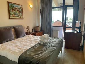 a bedroom with a bed with a towel on it at Hotel Shterev Anevo in Sopot +12 photos