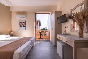 a hotel room with a bed and a tv at Yria Hotel in Zakynthos Town