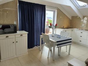 a kitchen with a table and chairs and a window at LekkeBly Boutique Loft - Solar in Paternoster