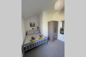 a bedroom with a bed with yellow pillows on it at No 10 Immaculate City Centre, Top Floor 2 Bed Flat with Free Parking in Inverness