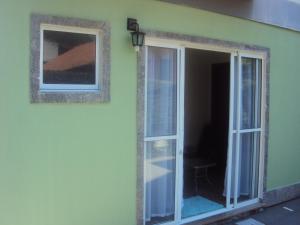 a room with a sliding glass door with a window at Sweet Rio Residence Taquara in Rio de Janeiro