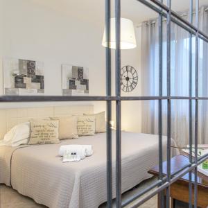 a bedroom with a bed and a clock on the wall at Albergo Al Castello in Gavi +67 photos