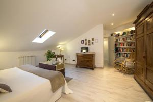 a bedroom with a bed and a desk and a book shelf at Albergo Al Castello in Gavi
