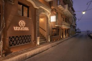 a building with a sign on the side of a street at Yria Hotel in Zakynthos Town