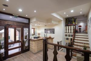 a lobby with a staircase and a stair case at Yria Hotel in Zakynthos +118 photos