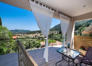 a view from the balcony of a house with a table and chairs at Casa De Blue in Kariá