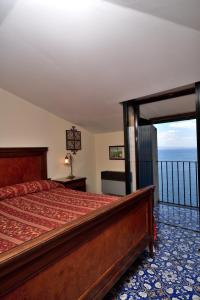 a bedroom with a bed with a view of the ocean at Hotel La Tonnarella in Sorrento
