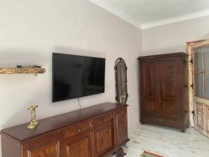 a living room with a television on a wall at Casa Poetului in Sibiu +3 photos