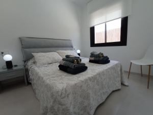 a bedroom with a bed with two pillows on it at Villa Xavi Sucina in Murcia