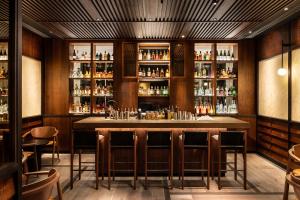 a bar in a restaurant with a lot of bottles at The Prince Akatoki London in London