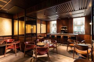 a restaurant with tables and chairs and a bar at The Prince Akatoki London in London