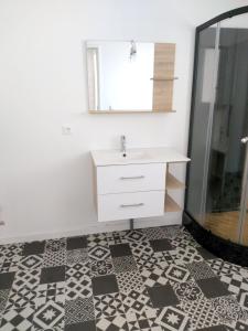a bathroom with a sink and a mirror at Maison d'une chambre avec jardin clos et wifi a Audenge a 3 km de la plage in Audenge