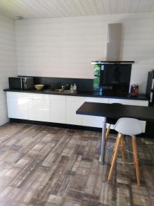 a kitchen with a counter and a table and chairs at Maison d'une chambre avec jardin clos et wifi a Audenge a 3 km de la plage in Audenge