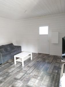 a living room with a couch and a coffee table at Maison d'une chambre avec jardin clos et wifi a Audenge a 3 km de la plage in Audenge