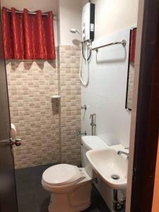 a small bathroom with a toilet and a sink at Reddoorz @ Sta Cruz Naga City in Naga