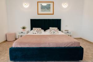een slaapkamer met een groot bed en 2 tafels bij Wait`N Sea House in Tuzla