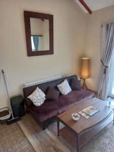 a living room with a couch and a table at Country Cottage Apartment Valentia Island Kerry in Valentia Island