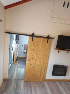 a sliding barn door in a room at Country Cottage Apartment Valentia Island Kerry in Valentia Island