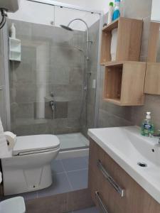 a bathroom with a shower and a toilet and a sink at oasi scala dei turchi in Realmonte +13 photos