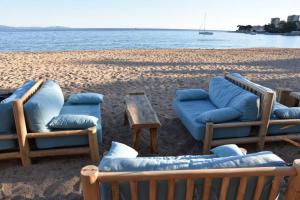 a group of chairs and a table on a beach at Appartement plein de charme - Ajaccio hyper centre in Ajaccio
