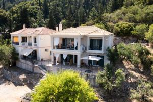 an aerial view of a white house with trees at Casa De Blue in Kariá